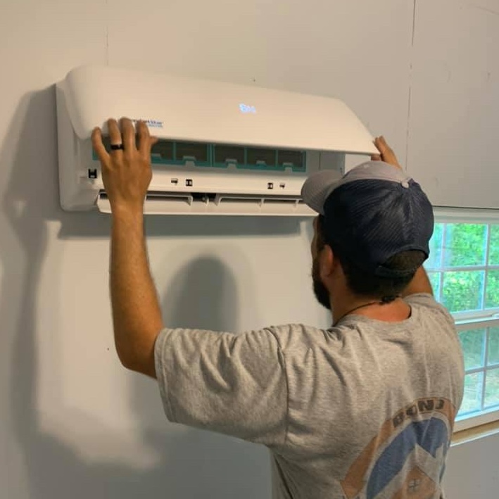 man working on interior ac unit